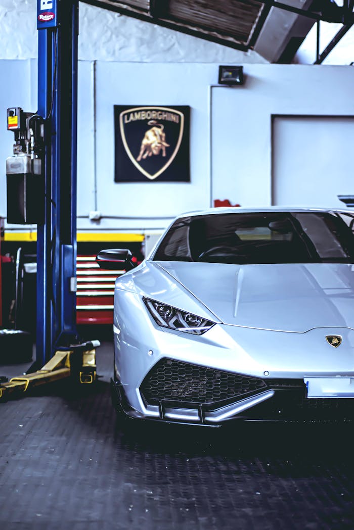 Silver Lamborghini Huracan parked in a high-end garage, showcasing luxury and performance.